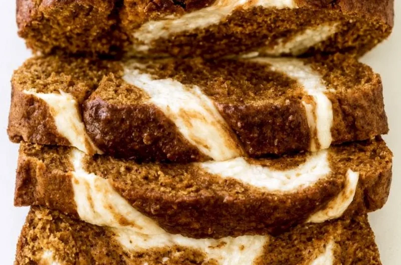 Loaf of delicious Pumpkin Cream Cheese Bread on a wooden table
