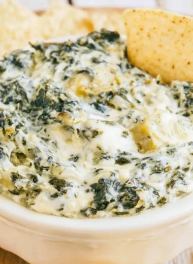Creamy slow cooker spinach artichoke dip served with tortilla chips