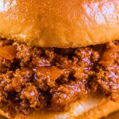 Delicious and messy Sloppy Joes served on a plate with sides