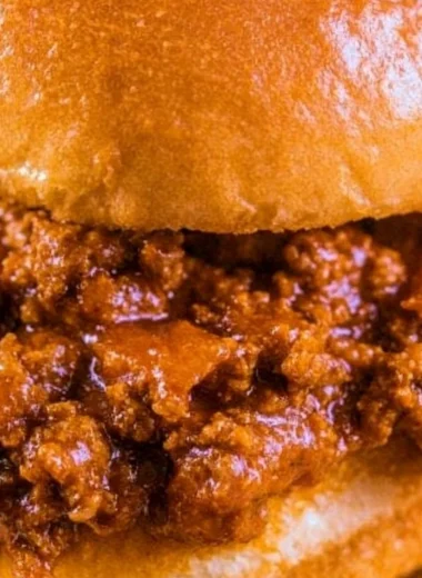 Delicious and messy Sloppy Joes served on a plate with sides