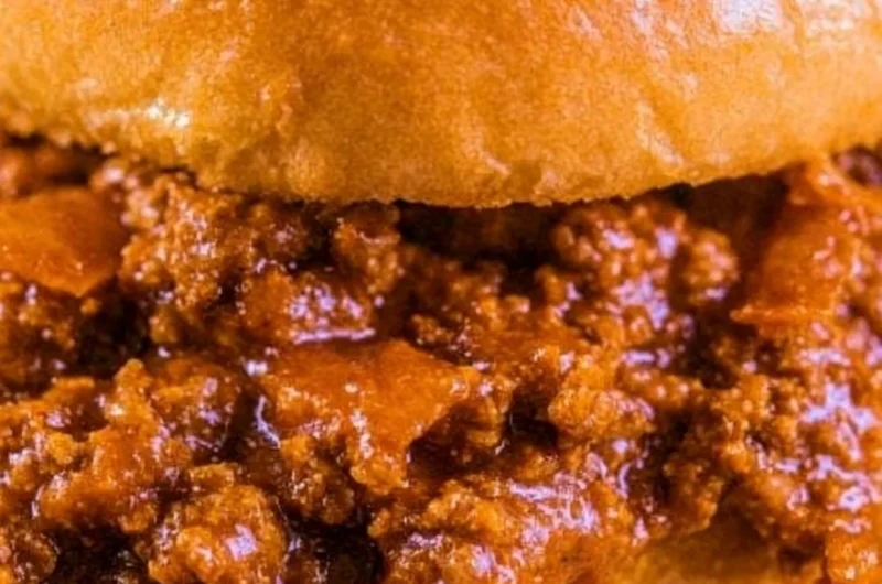 Delicious and messy Sloppy Joes served on a plate with sides