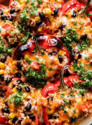 Plate of colorful vegetarian stuffed peppers filled with grains and vegetables
