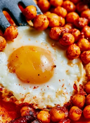 Cozy chickpea fried eggs served with fresh herbs for a warm dinner.
